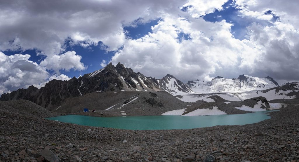 Adygene Lake beneath the glacier and surrounding rocky slopes. Photo by Nikolay Okhotnikov.