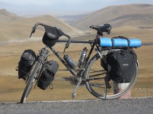 A loaded touring bicycle: an equipment illustration; the image does not document a Kyrgyzstan route.